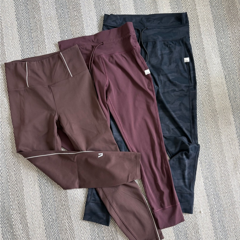 Set of Three Vuori Athletic Leggings in Brown, Burgundy, and Black